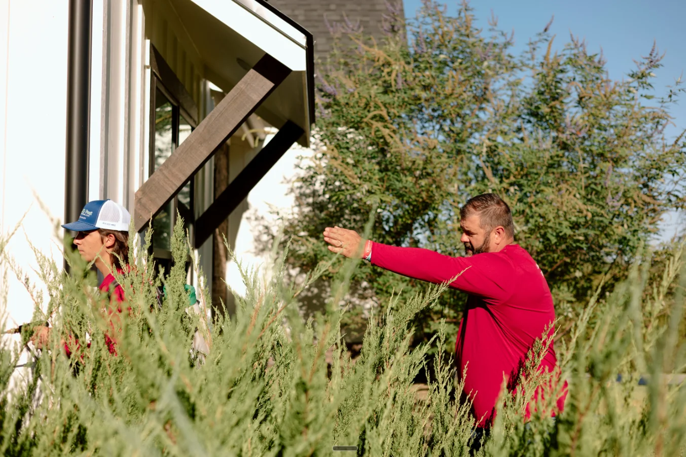 Jason treating around a tree at a residential home in Brazos Valley.