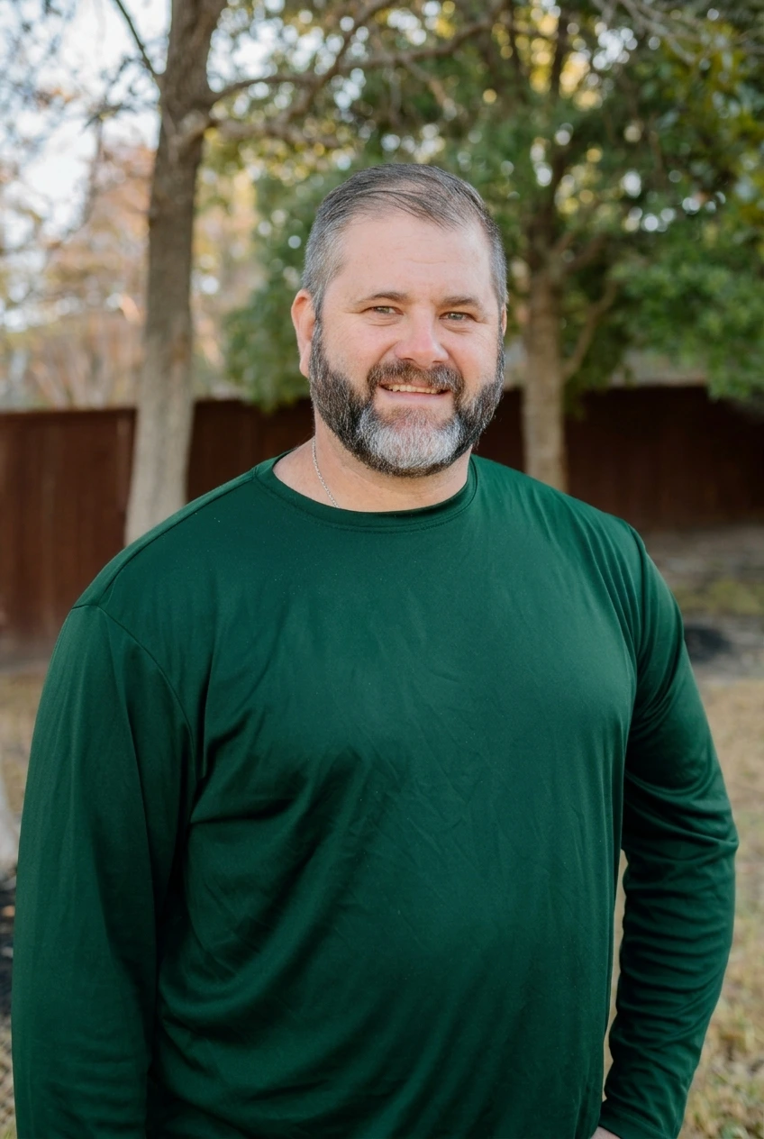 Jason Kempenski, owner of D&D Pest Services Brazos Valley, wearing a forest green D&D Pest Services long-sleeve shirt.